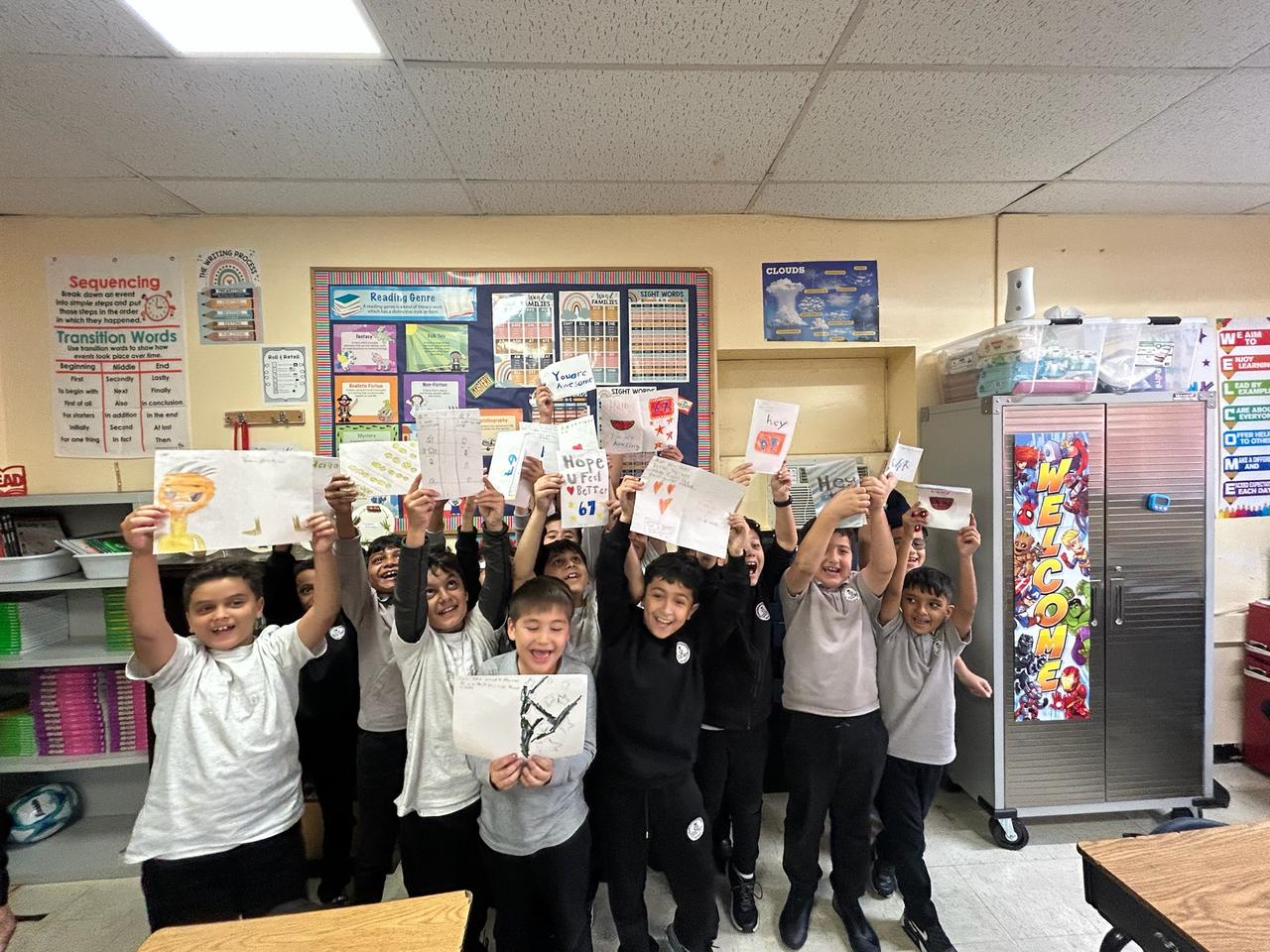 Student volunteers holding up their handmade cards